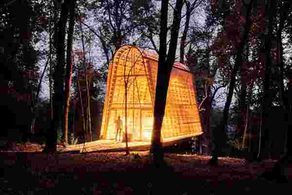 This A-frame, cantilever cabin comes wrapped in a mesh that makes it glow in the dark come nighttime